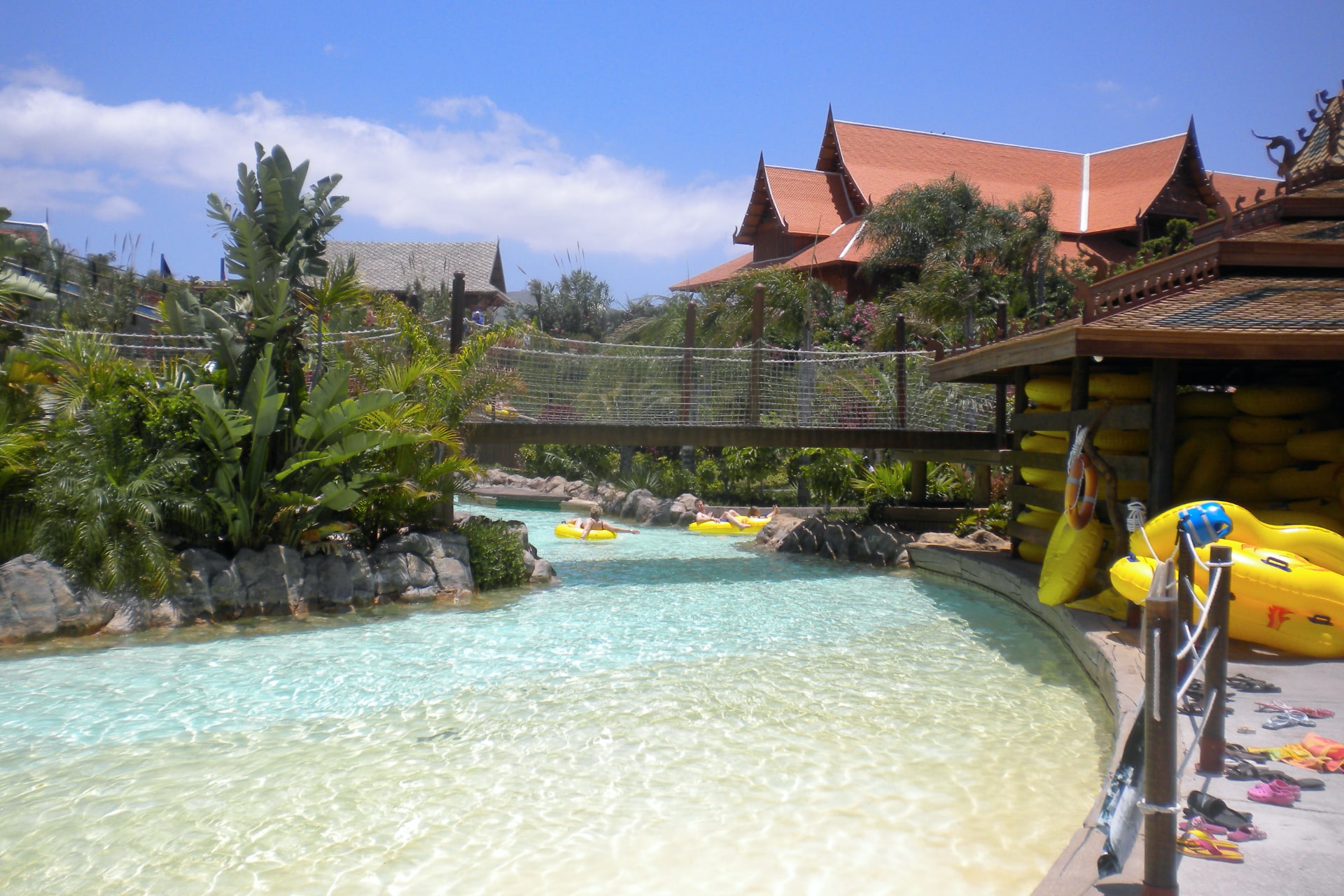 Bridge under the lazy river at Siam Park, Tenerife, offering a unique perspective and passage through the park's water attractions