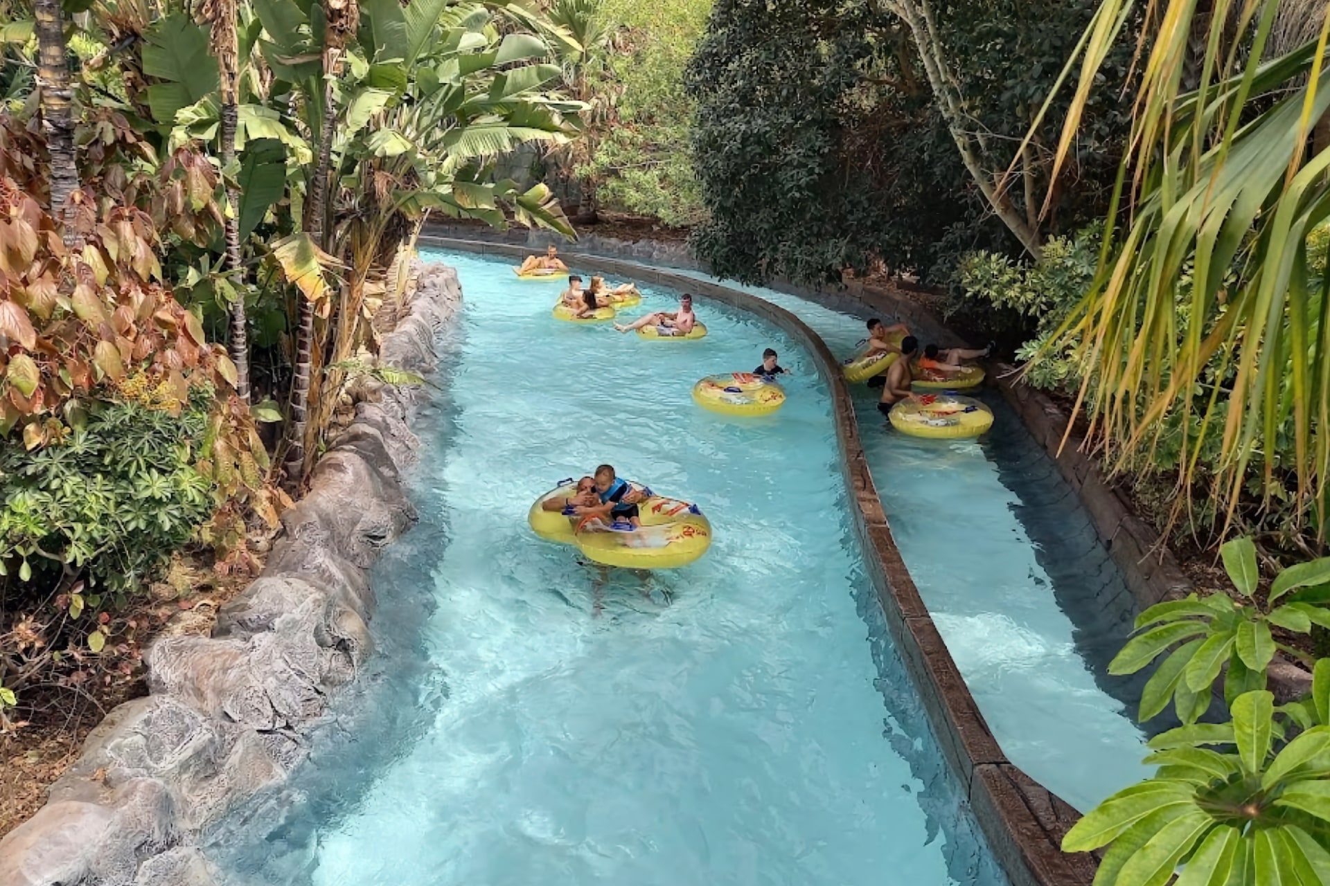 Scenic view of the lazy river winding through the tropical landscape at Siam Park, Tenerife