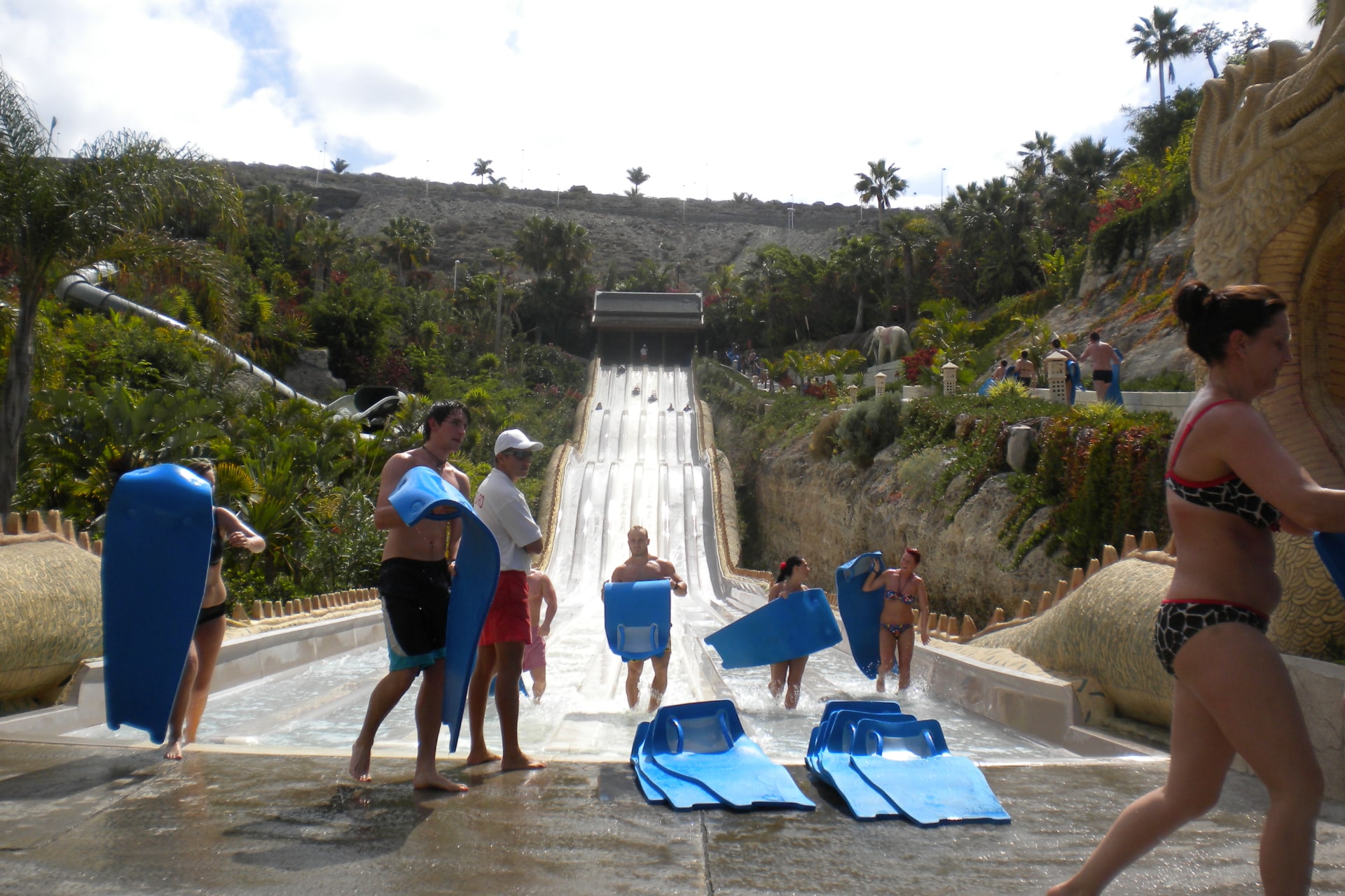 Excited participants crossing the finish line of Naga Racer at Siam Park, Tenerife