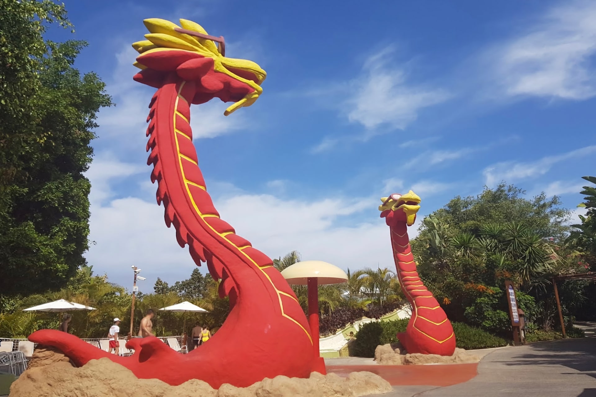 Two impressive statues of red dragons at Siam Park in Tenerife