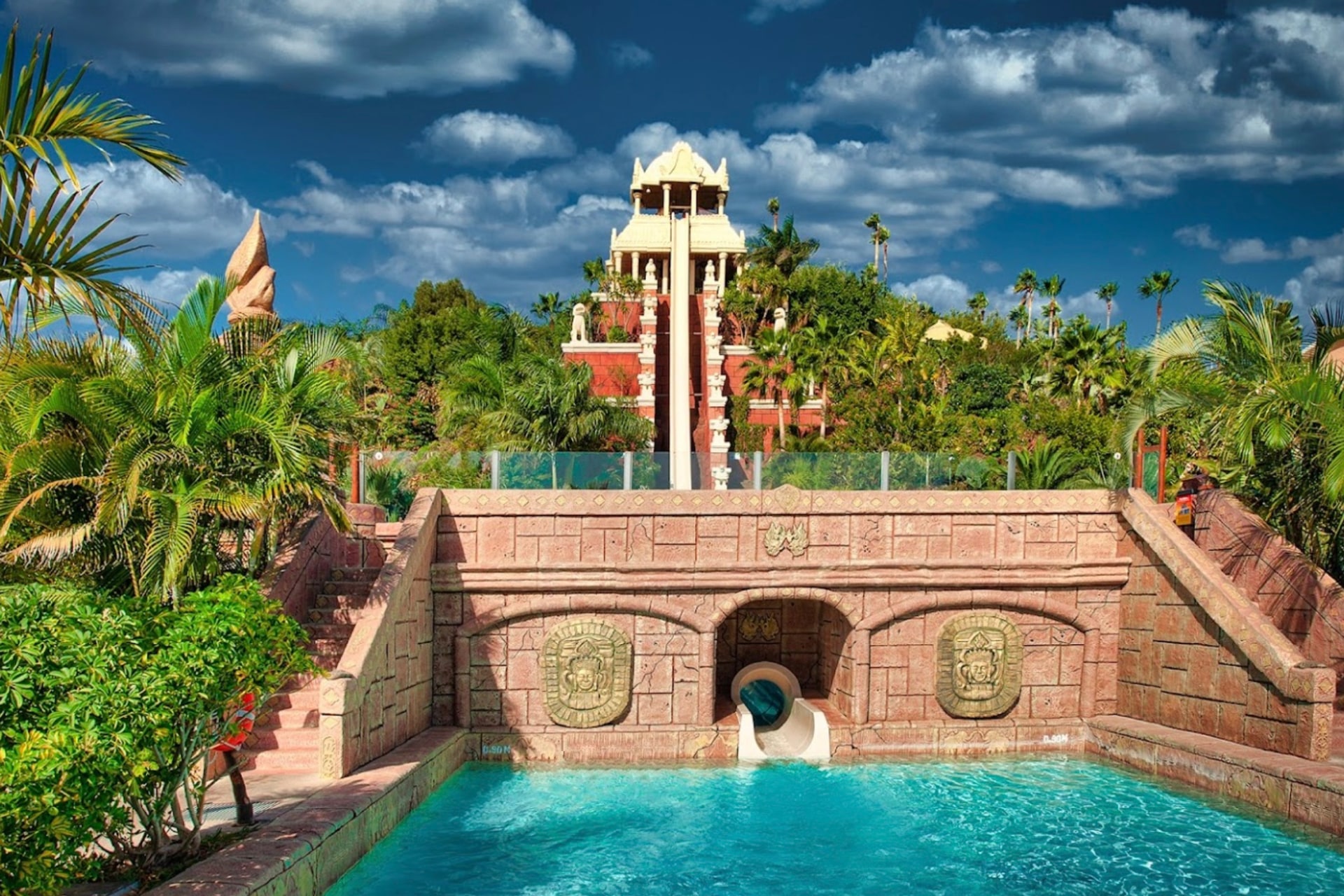 Vibrant lower view of the Tower of Power slide at Siam Park, Tenerife, against a clear blue sky